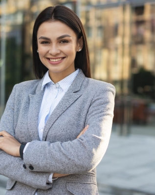 smiley-businesswoman-posing-outdoors-with-arms-crossed-and-copy-space